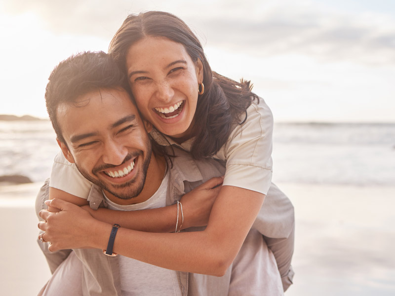 couple laughing together on the beach